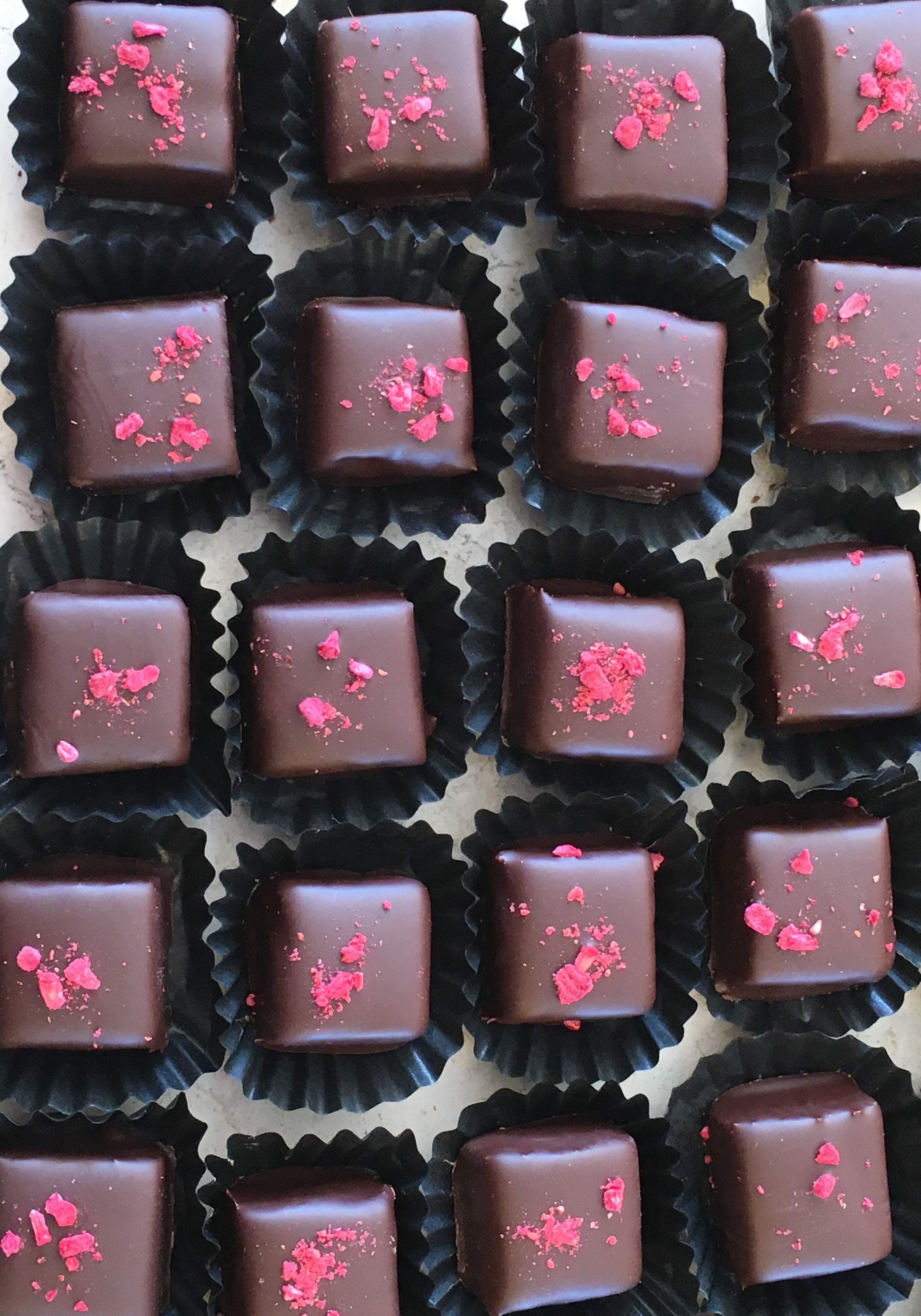 Hindbær ganache overtrukket med 66% mørk chokolade, pyntet med frysetørret hindbær